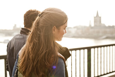 Germany, Cologne, young couple walking on bridge - FEXF000277