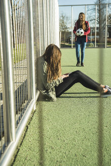 Two teenage girls on sports ground - UUF003071