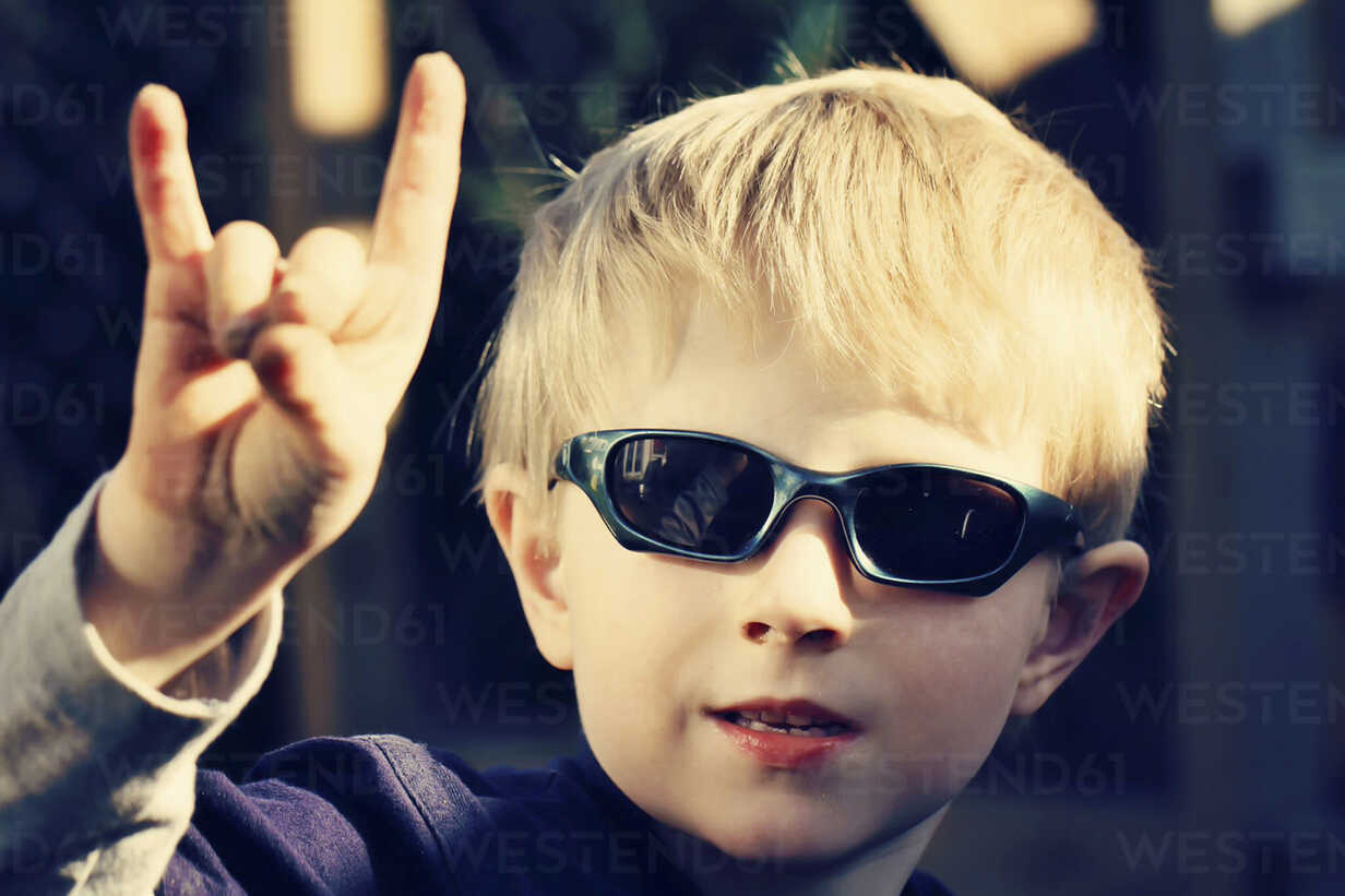 Blond boy wearing dark sunglasses stock photo