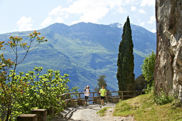 Italy, Trentino, couple running near Lake Garda - MRF001468