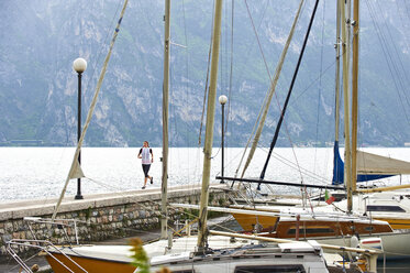 Italien, Trentino, Frau läuft am Gardasee - MRF001490