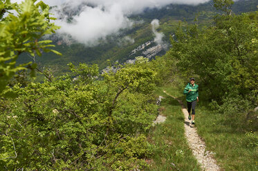 Italy, Trentino, man running near Lake Garda - MRF001517