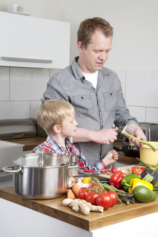 Father and son cooking stock photo