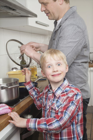 Portrait of boy cooking with his father stock photo