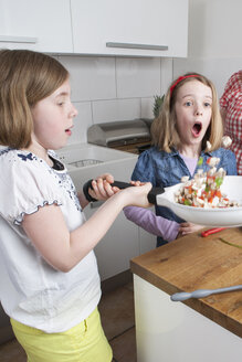 Two sisters cooking together - PATF000018