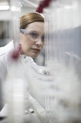 Scientist in lab working with liquids - ZEF004231