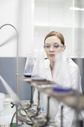 Scientist in lab working with liquids - ZEF004241