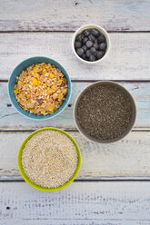 Organic chia seeds and popped amaranth, blueberries and glutenfree cereal in bowls - LVF002651