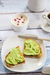 Bread with avocado cream, yogurt with pomegranate seeds and cup of coffee - LVF002662