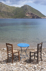 Greece, Porto Kagio, table and chairs by the sea - WWF003506