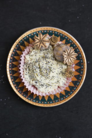 Tassenkuchen mit Mohnglasur und Mohnkapseln, lizenzfreies Stockfoto