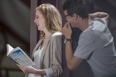 Two laughing students in a library - ZEF004263