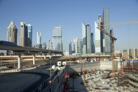 UAE, Dubai, construction site in front of skyscrapers stock photo