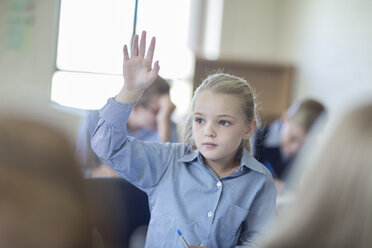 Schoolgirl in classroom raising her hand - ZEF004968