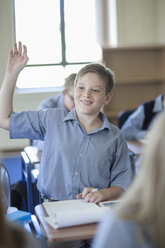 Schoolboy in classroom raising his hand - ZEF004969