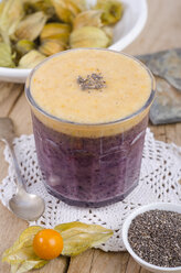 Glass of blueberry pudding with physalis mush and chia seeds - ODF001086