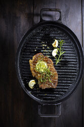 Rump steak with herbed butter, rosmary and garlic in frying pan - KSWF001412