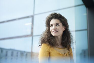 Smiling young woman at the window - RBF002336