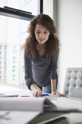 Young woman working at desk in office - RBF002351