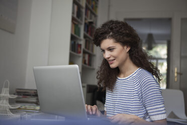 Young woman at home using laptop - RBF002308