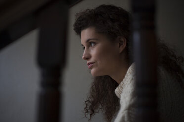 Sad young woman on staircase - RBF002259