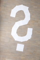 Sheets of paper in shape of question mark on floor - MFRF000005