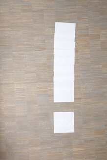 Sheets of paper in shape of exclamation mark on floor - MFRF000007