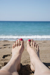 Greece, Peloponnese, woman's feet on the beach - CHPF000012