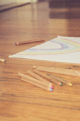 Sketch block and colored pencils on timber floor - LVF002729