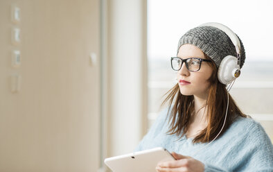 Young woman with digital tablet and headphones - UUF003252