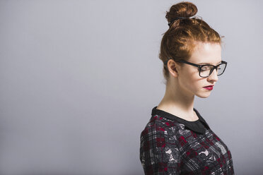 Young woman with glasses and bun - UUF003299