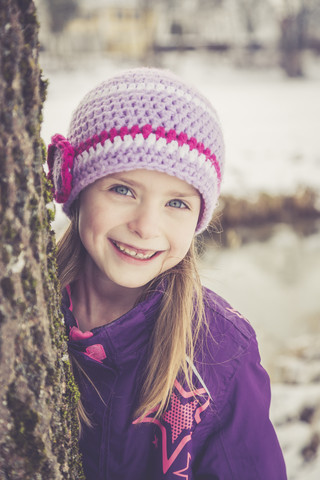 Portrait of smiling little girl in winter stock photo