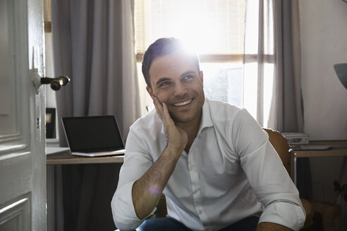 Portrait of smiling man at his home office - PDF000705