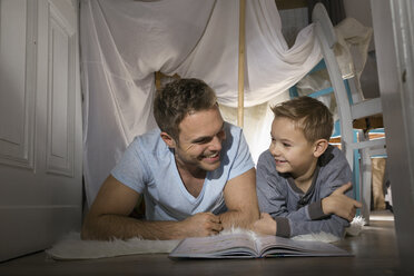 Father and son having fun in self-made tent at home - PDF000722