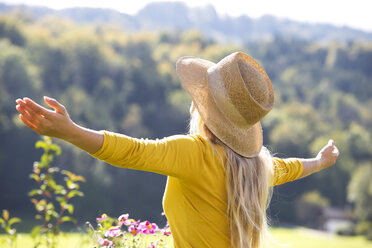 Relaxed teenage girl with outstretched arms - WWF003823