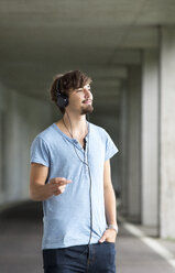 Young man hearing music with headphones - WWF003721