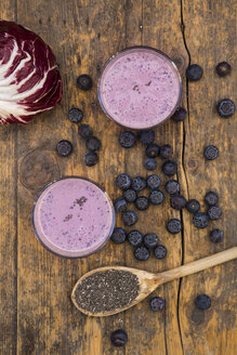 Two glasses of blueberry radicchio smoothie and wooden spoon with chia seeds - LVF002756