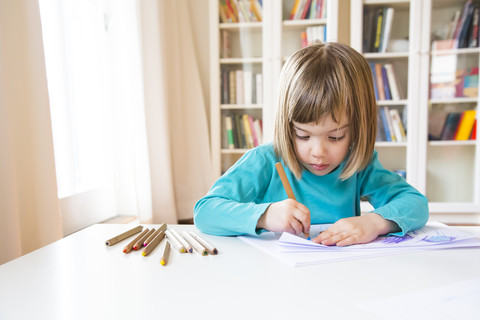 Little girl drawing stock photo