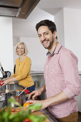 Couple cooking in kitchen - RBF002376