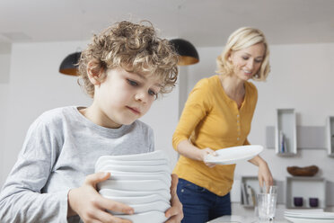 Mother and son laying the table - RBF002408