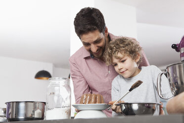 Father and son baking in kitchen - RBF002423