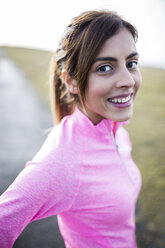 Spain, Gijon, portrait of smiling young woman outdoors - MGOF000075