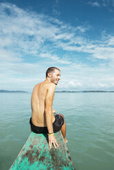 Philippines, Palawan, El Nido, man sitting on the bow of a boat - GEMF000034