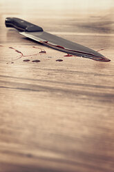 Blood stained knife on wooden floor - MID000056