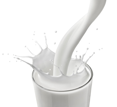 Milksplashing in front of white background stock photo