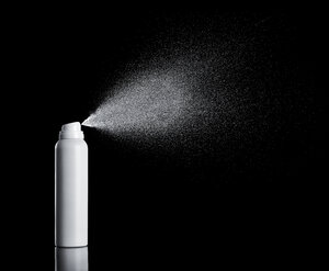 White spraying aerosol can in front of black background - RAMF000047