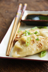 Pan-fried gyoza, japanese dumplings with an asparagus and shitake filling - HAWF000636