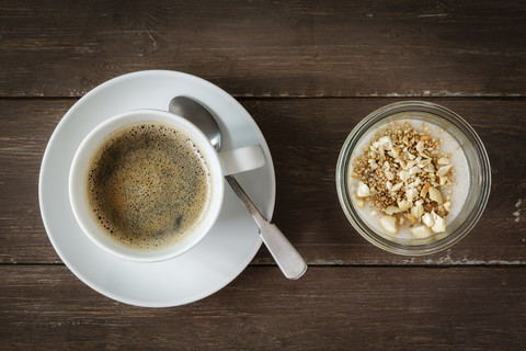 Cup of coffee and glass of vegan cocos pudding with banana and tapioca granules stock photo