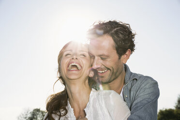 Laughing couple at backlight - PDF000790