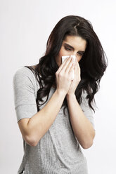 Young woman blowing nose - GDF000671